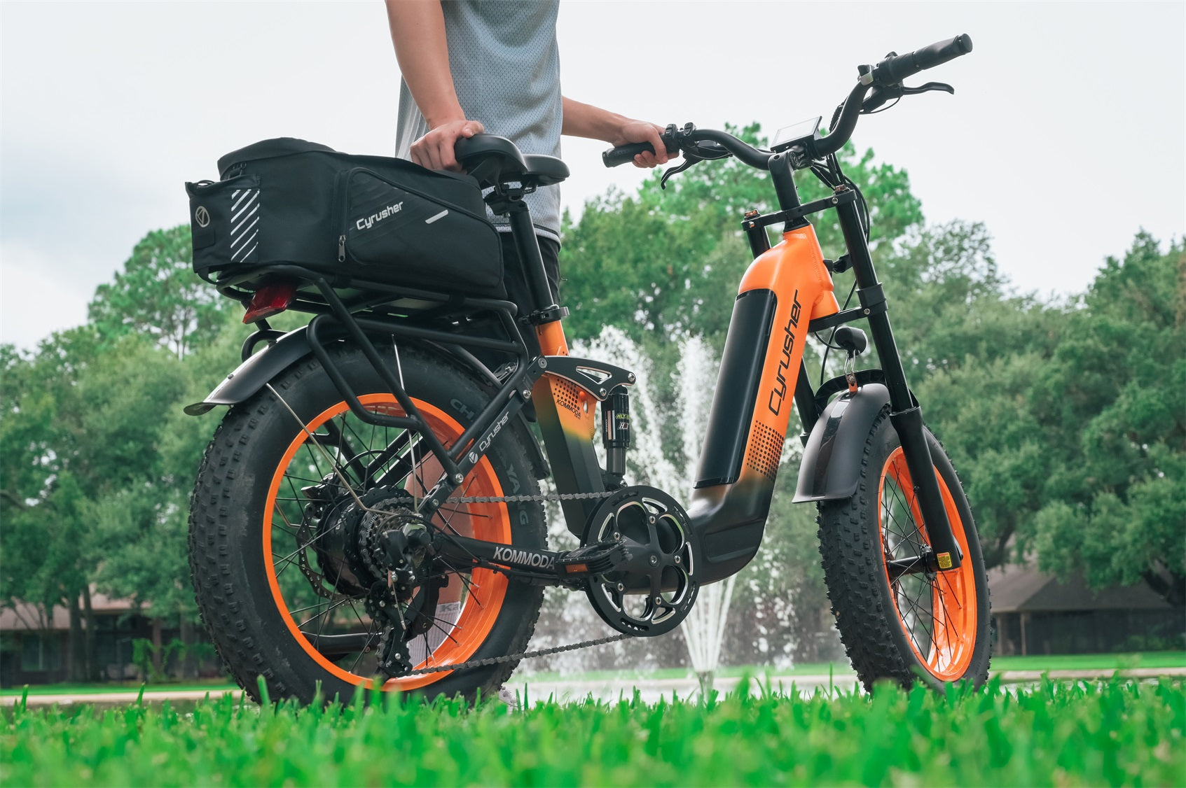 A man rides an electric bike on the grass.-0902